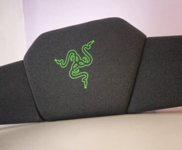 Photo by Rosalie Newcombe of the Razer Clio wireless speaker head cushion sitting on a white desk.