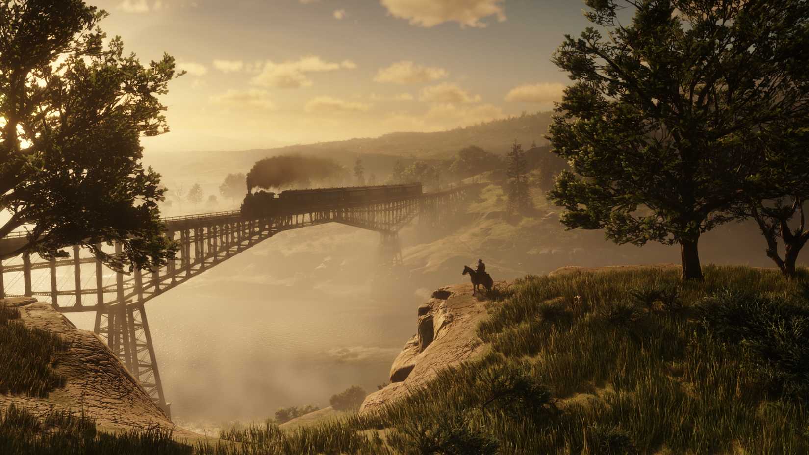 a steam train crosses a bridge over a river at golden hour in Red Dead Redemption 2