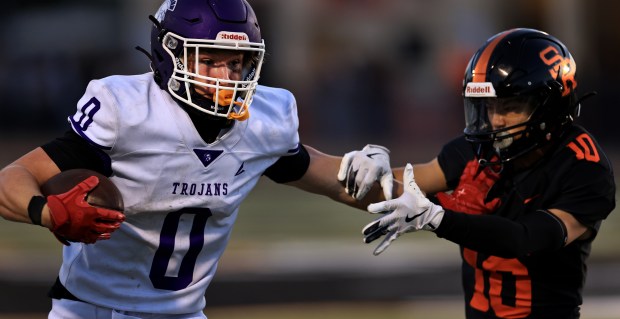 Petaluma ball carrier Jonah Crichton pushes Santa Rosa defender Owen Nojima away en route to a touchdown during their game earlier this month. (Kent Porter - The Press Democrat)