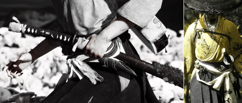 Close-up of a person dressed in traditional samurai clothing, gripping the hilt of a katana. Another samurai, wearing a straw hat and yellow robe, stands on the right, also holding a sword at their waist.
