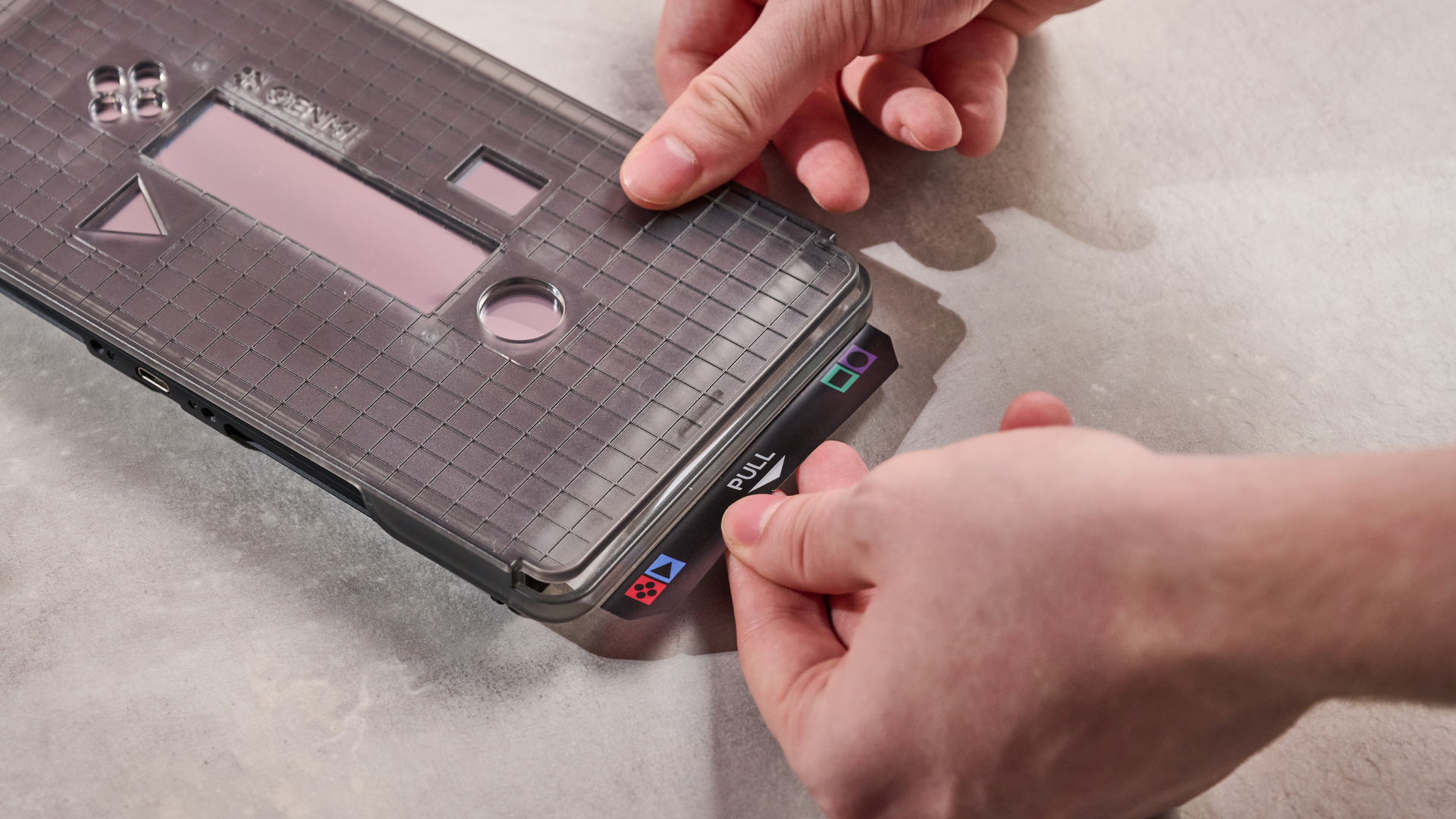 Person pulling tab attached to the Genki Aegis Shield