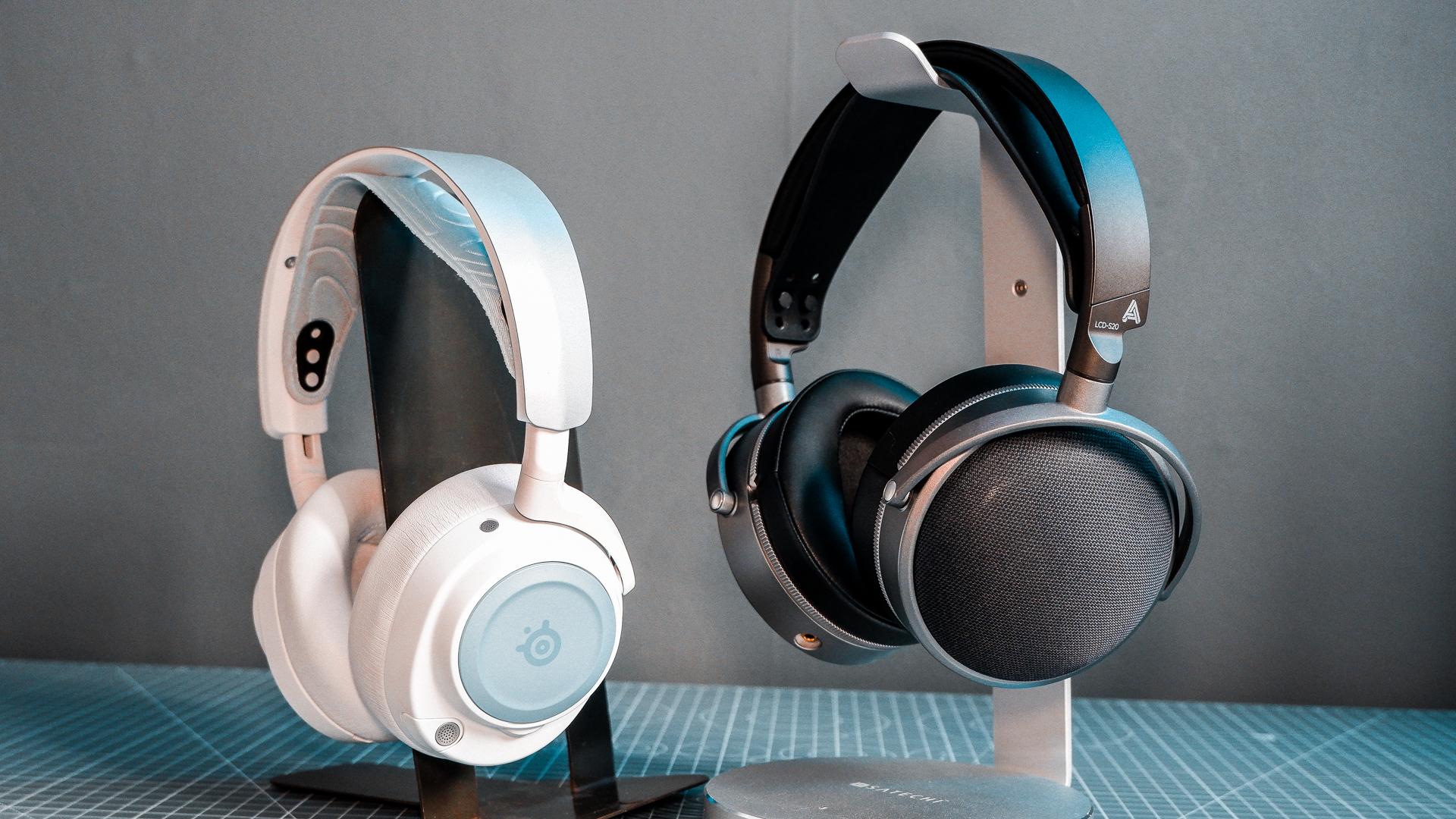 Two pairs of headphones. One, a SteelSeries set with ANC; the other, an Audeze set with great passive sound isolation.