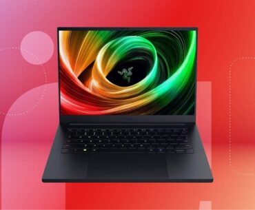 An open black laptop against a red gradient CNET background.
