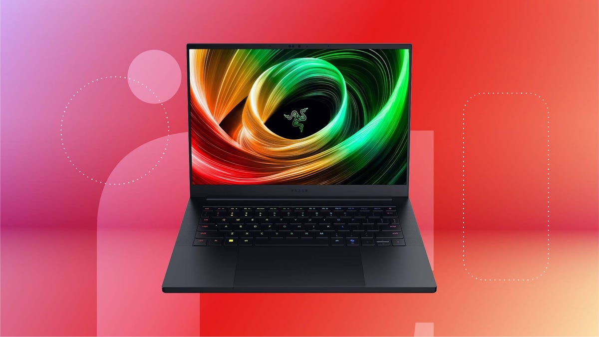 The 2025 Razer Blade 14 Gaming Laptop Just Got Its First-Ever Discount An open black laptop against a red gradient CNET background.