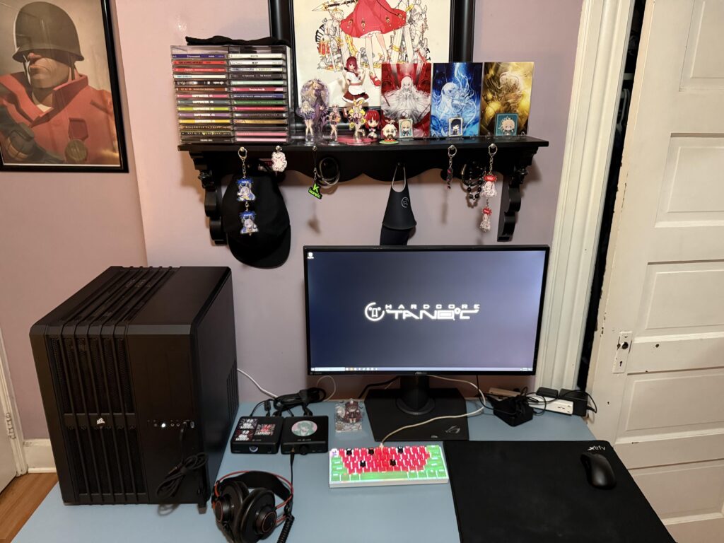 My setup. My room is very small so the shelf above my computer is where I keep my figurines, accessories, cd’s and whatnot.