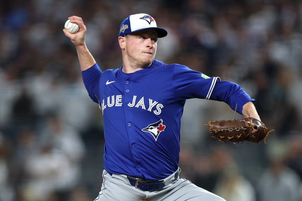 Louis Varland #77 of the Toronto Blue Jays pitches against the New York Yankees.