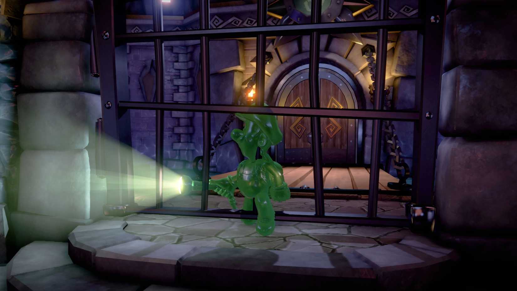 Gooigi walking through an iron bar doorway in a castle in Luigi's Mansion 3.