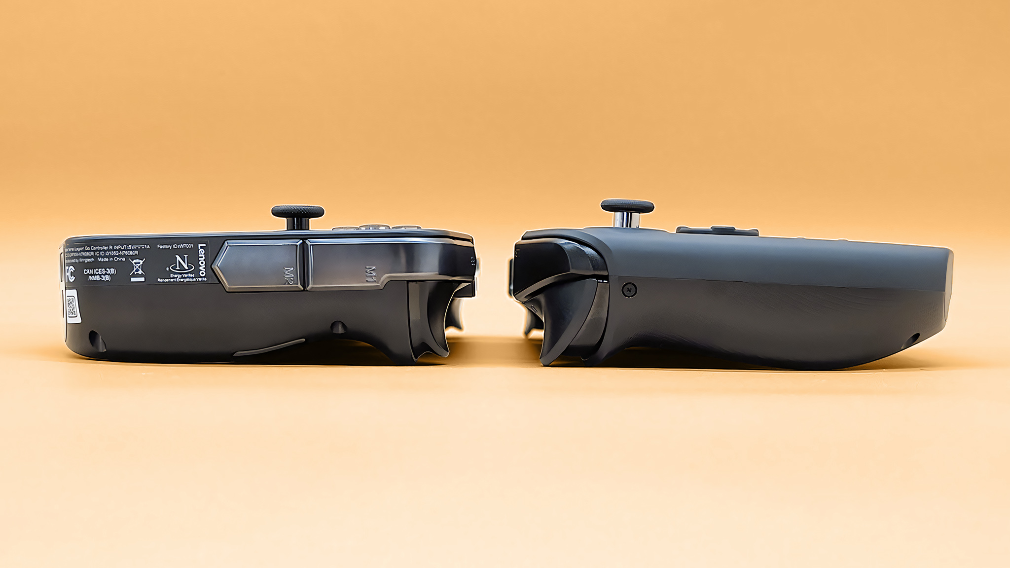 A profile view of the Lenovo Legion Go 2 and the original Legion Go lying toward each other. The Legion Go 2 is slightly thicker. 