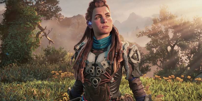 Aloy looking up with the forest behind her