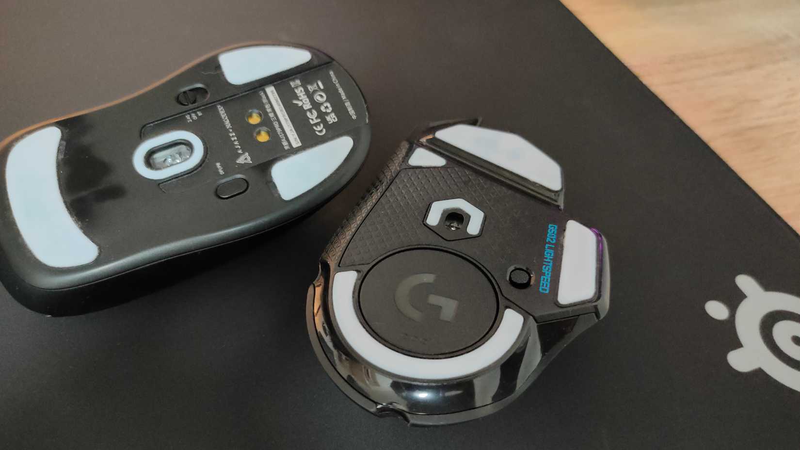 Custom mouse skates on the underside of the Logitech G502 Lightspeed and Ajazz AJ 179 Pro gaming mice.