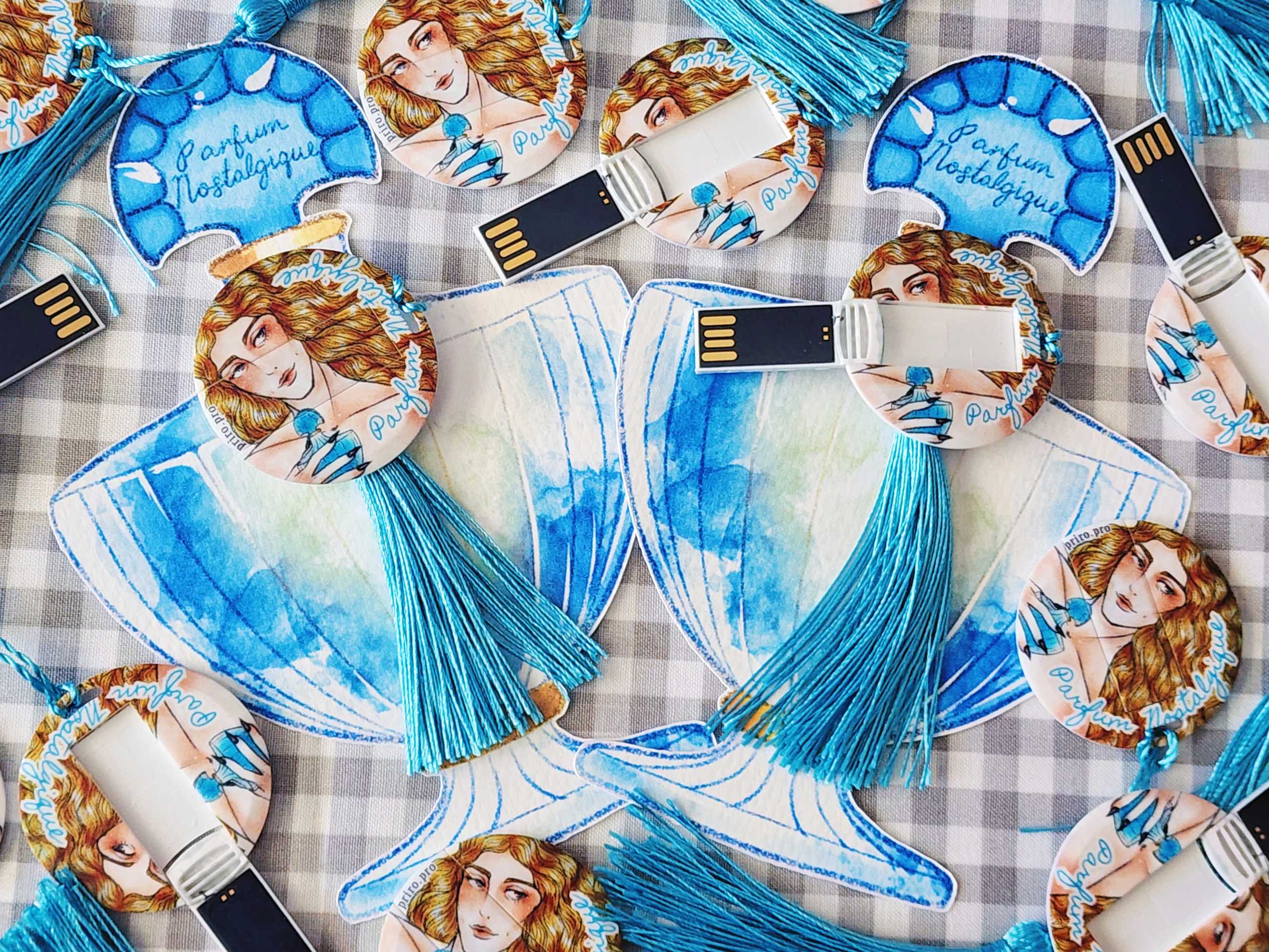 A collection of physical copies of Parfum Nostalgique, a visual novel with LGBT themes. The USB is shaped to look like it is a perfume bottle.