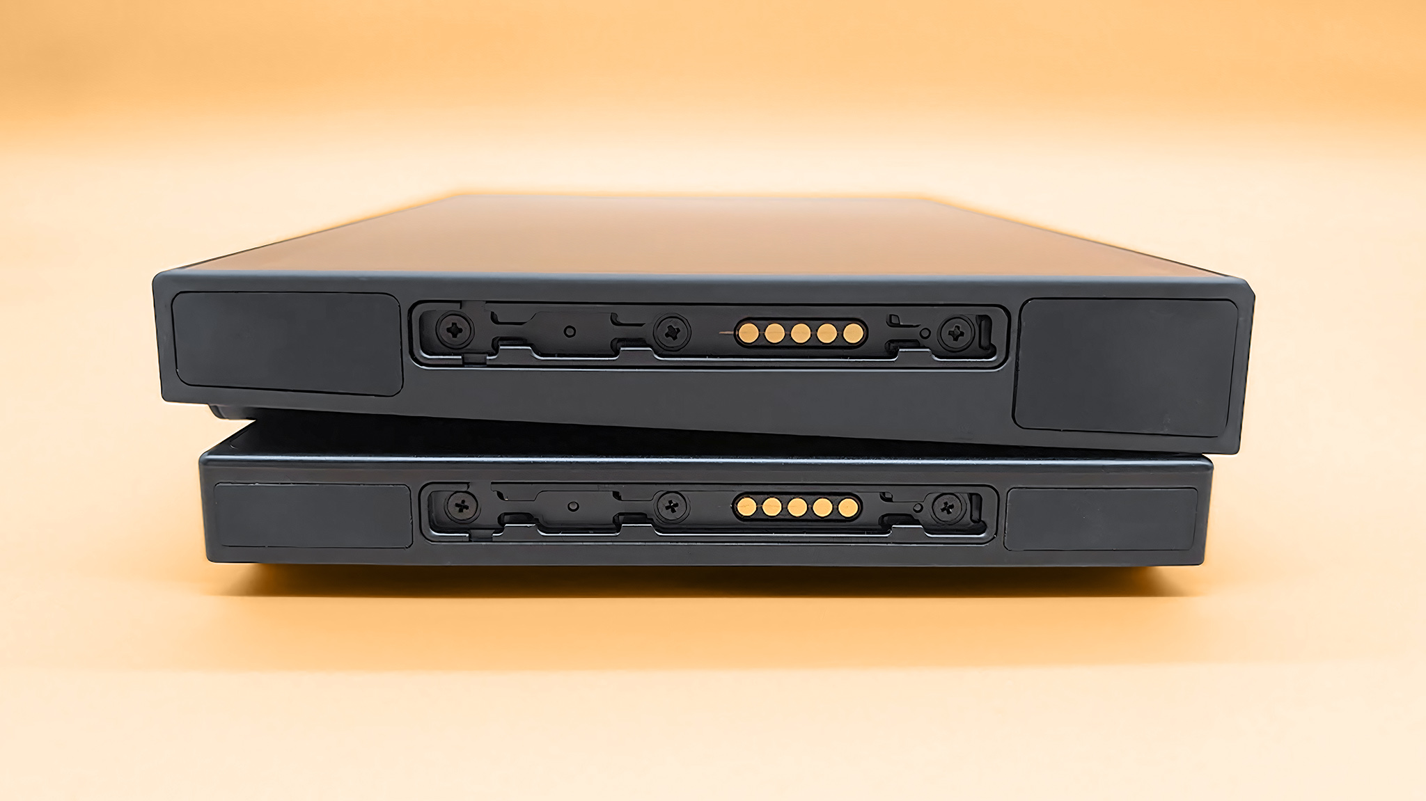 The Lenovo Legion Go 2 screen on top of the original Legion Go. The camera is angled to give a look at the controller connection area. 