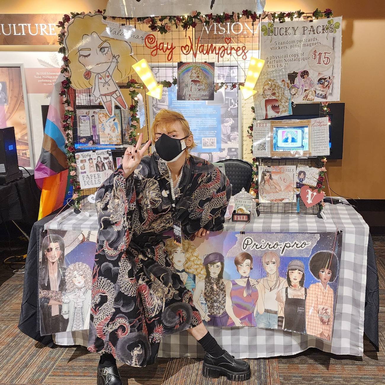Rosario, an indie game developer, shows off a real-world display at an event where he sold physical copies of his visual novel.