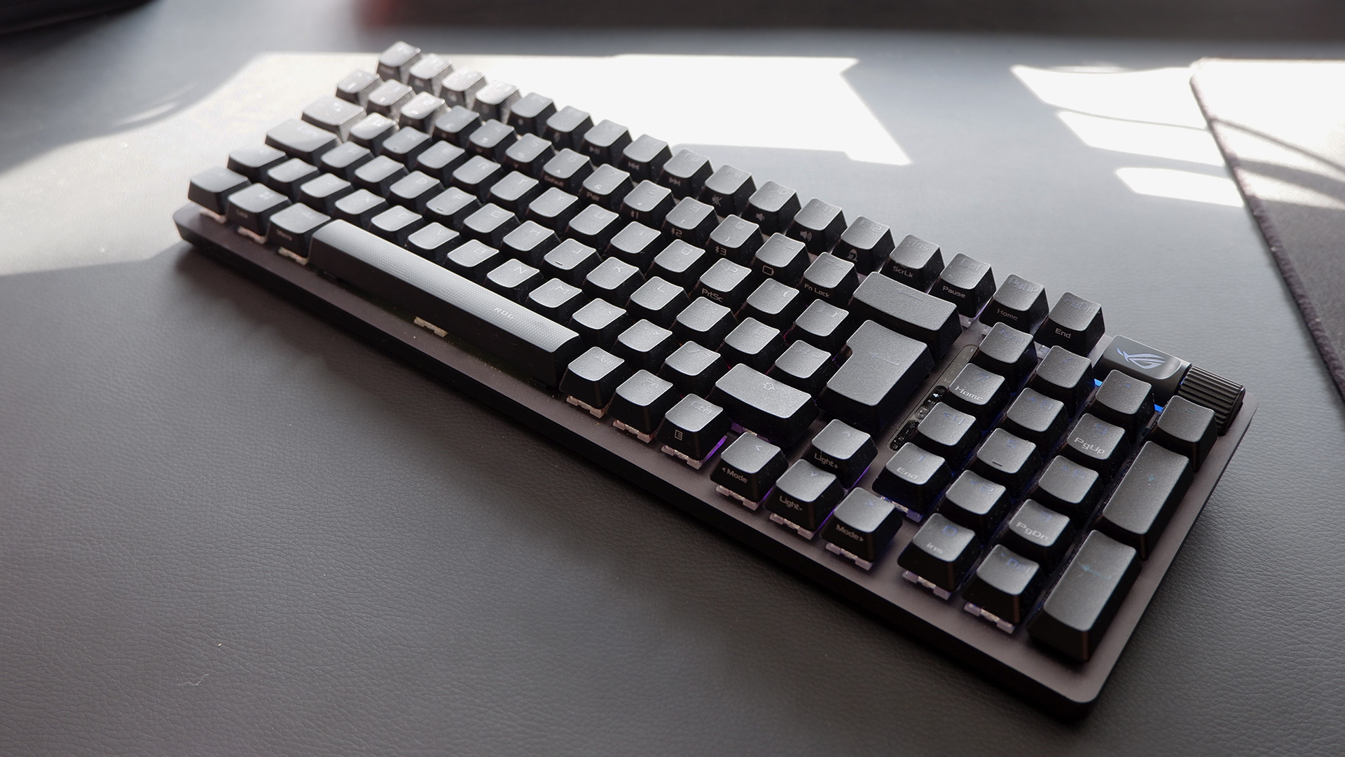 Asus ROG Strix Scope II 96 Wireless gaming keyboard on a desk.