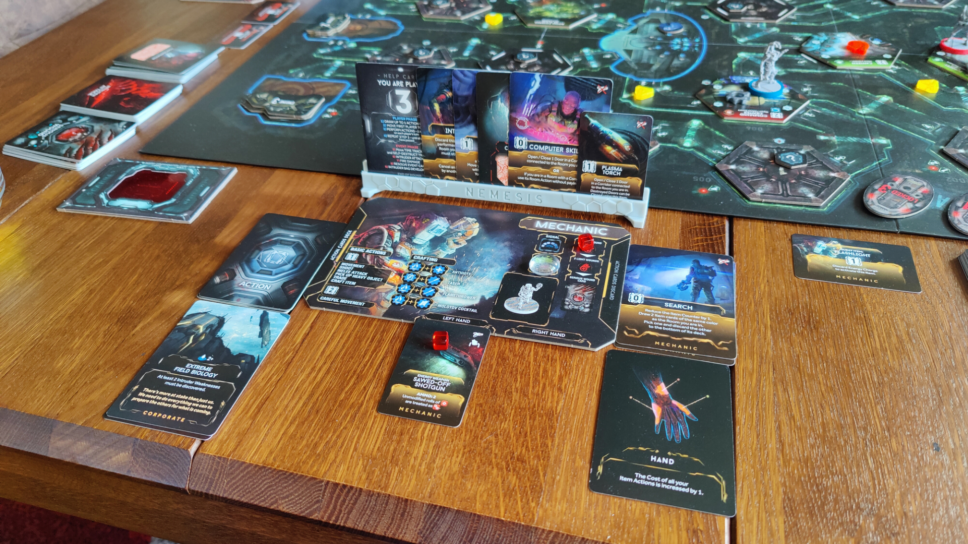 A player board and their cards in a game of Nemesis.