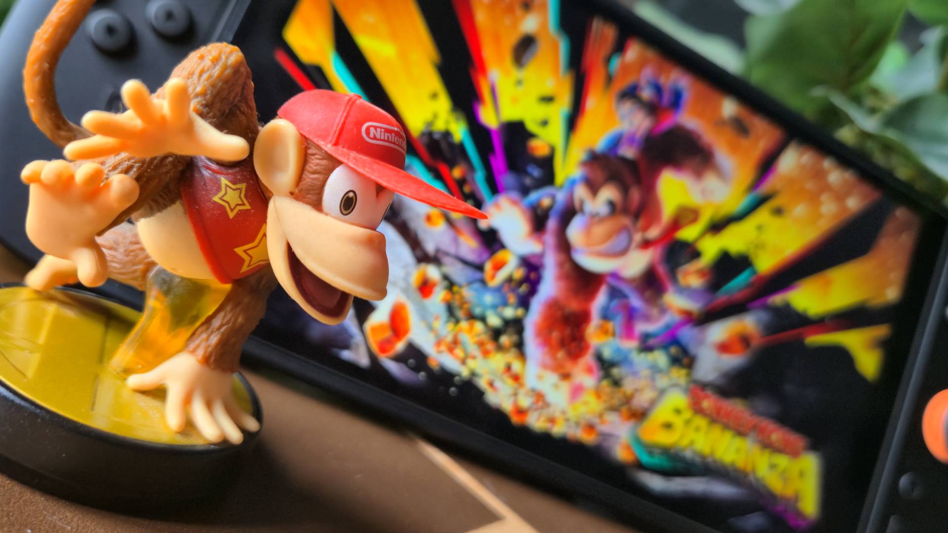 Photo of the Diddy Kong Smash Bros amiibo sitting in-front of a Nintendo Switch 2.