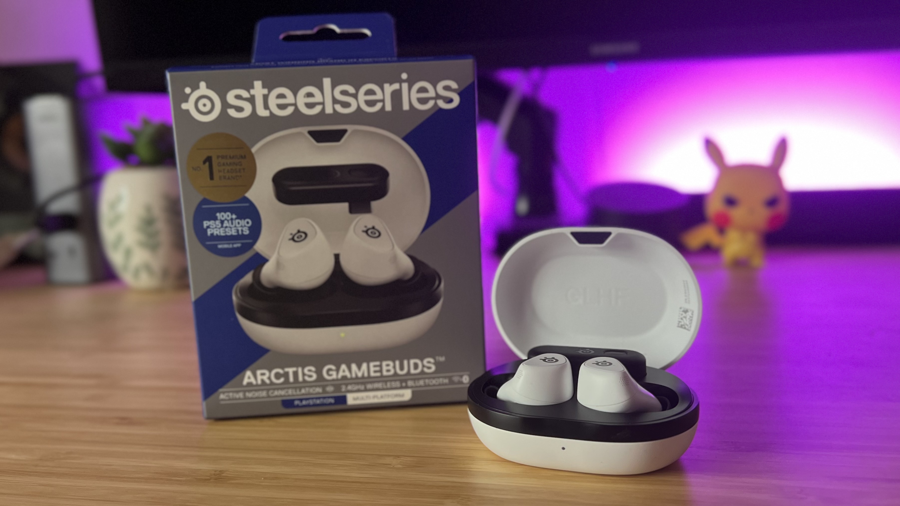 SteelSeries Arctis Game Buds with packaging on a wooden desk