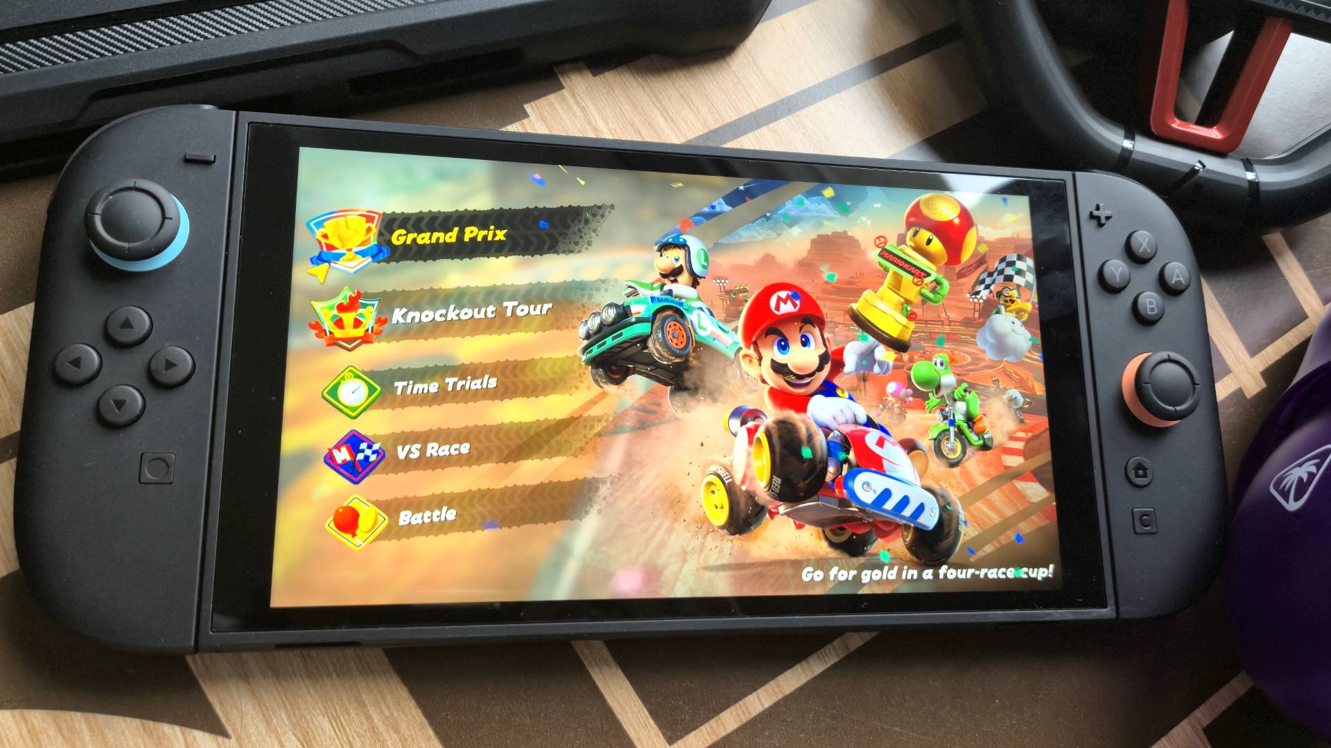 Photo of the Nintendo Switch 2 sitting on a coffee table surrounded by accessories.