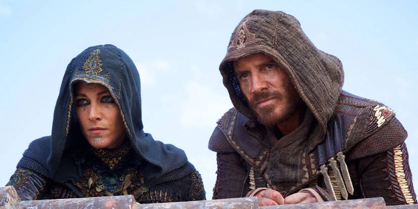Cal sits on a rooftop with a woman in Assassin's Creed Movie