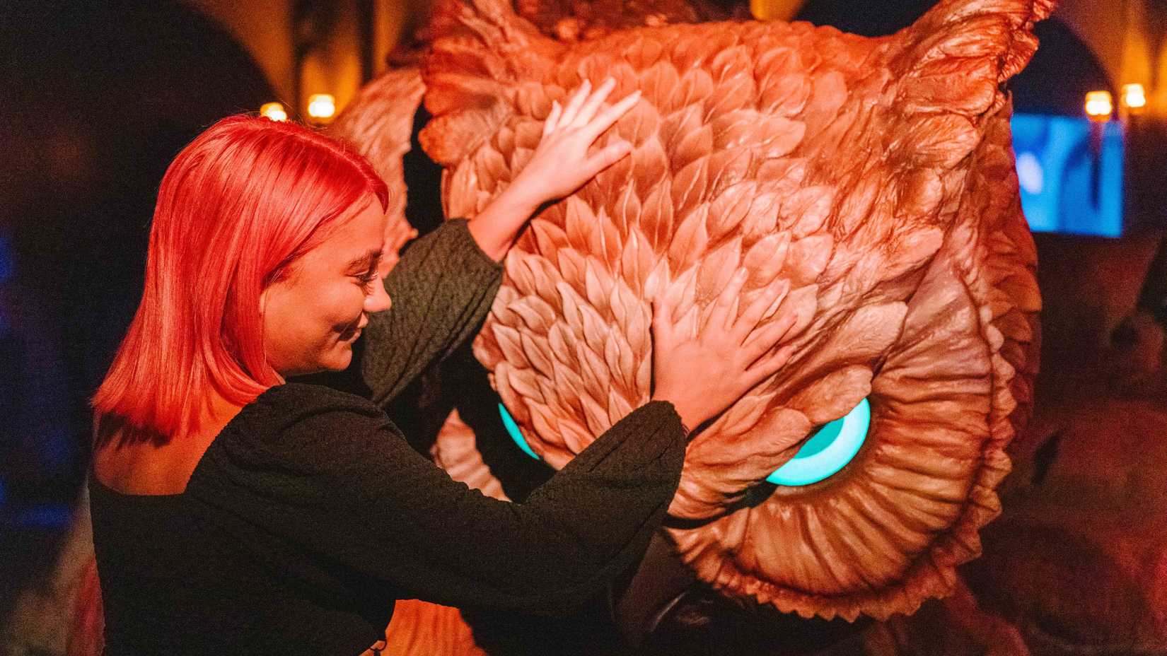 A woman pets an owlbear in Dungeons & Dragons: The Immersive Quest