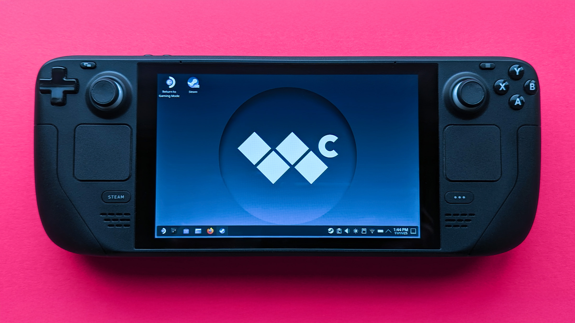 Valve Steam Deck (LCD) handheld gaming PC on a pink card background