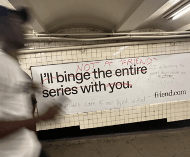 Graffitied AI website ads in NYC