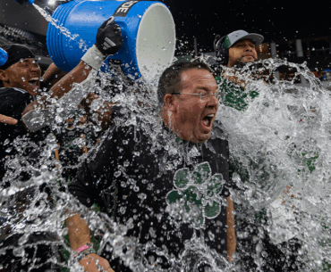 Ohio Football interim head coach John Hauser getting splashed with water after winning the Frisco Bowl.