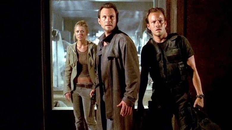 Aline Cedrac, Edward Carnby, and Richard Burke stand shocked in a doorway in 