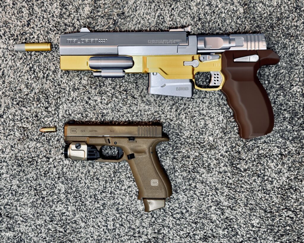 I 3D printed a replica of Johnny Silverhand’s Malorian Arms 3516 to a 1:1 scale correctly chambered in 14mm next to a real 9mm handgun for scale. No wonder it blows people’s limbs off in the game.