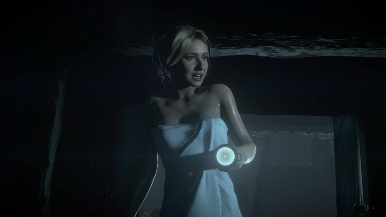 Sam Giddings walks around wrapped in a towel and carrying a flashlight in 