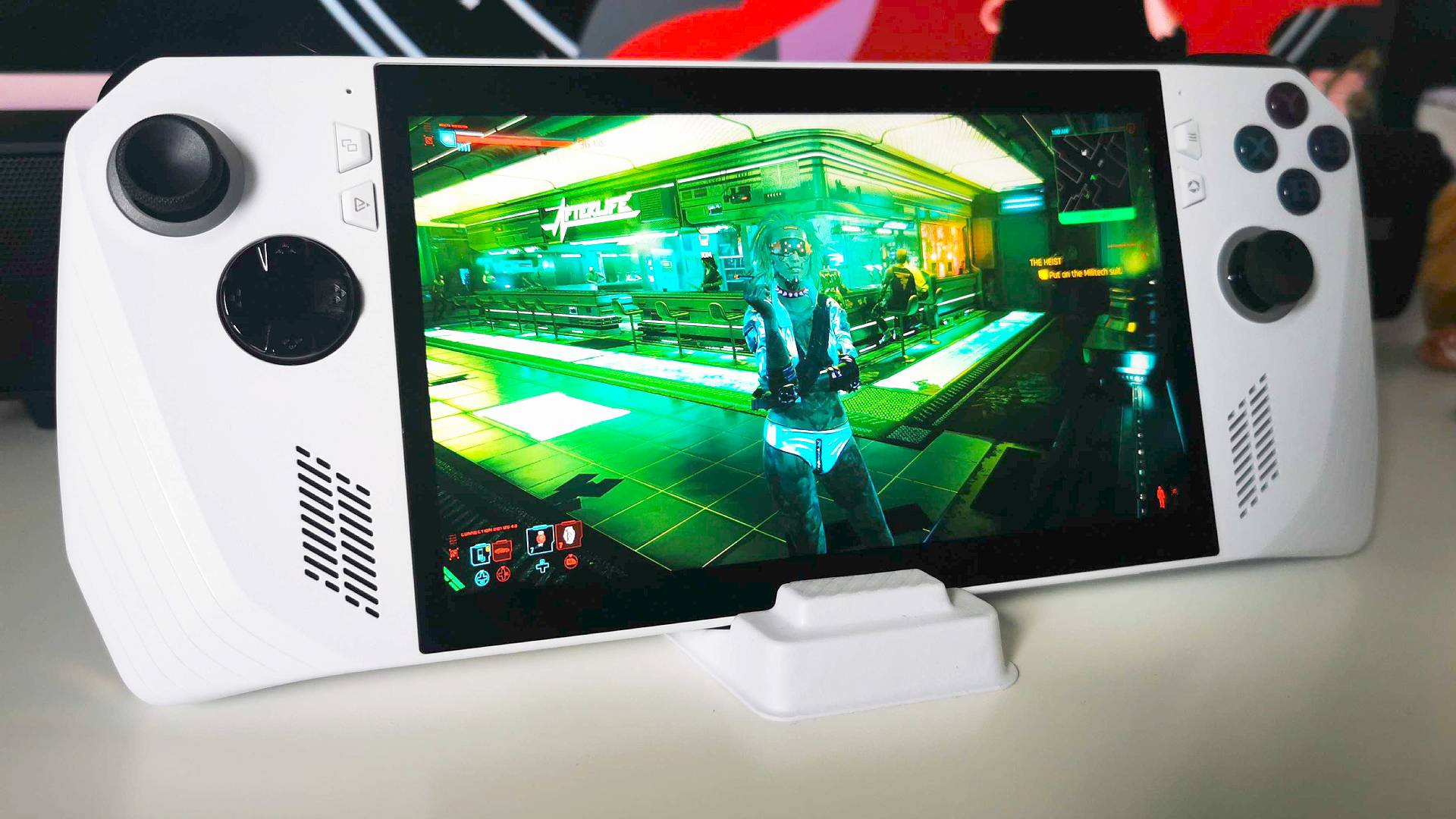 Asus ROG Ally with Cyberpunk 2077 gameplay on screen.