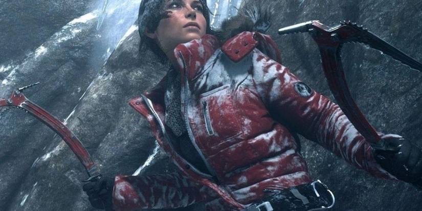 Lara is dressed for freezing weather and holding climbing gear in Rise of the Tomb Raider.