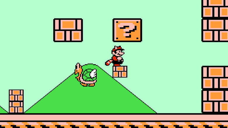 A Tanooki-suited Mario stand under an enlarged question mark block by a large parakoopa in 