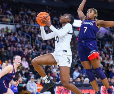 Payton Dunbar shooting a jump shot with a Villanova defender on her at Alumni Hall in Providence, R.I.
