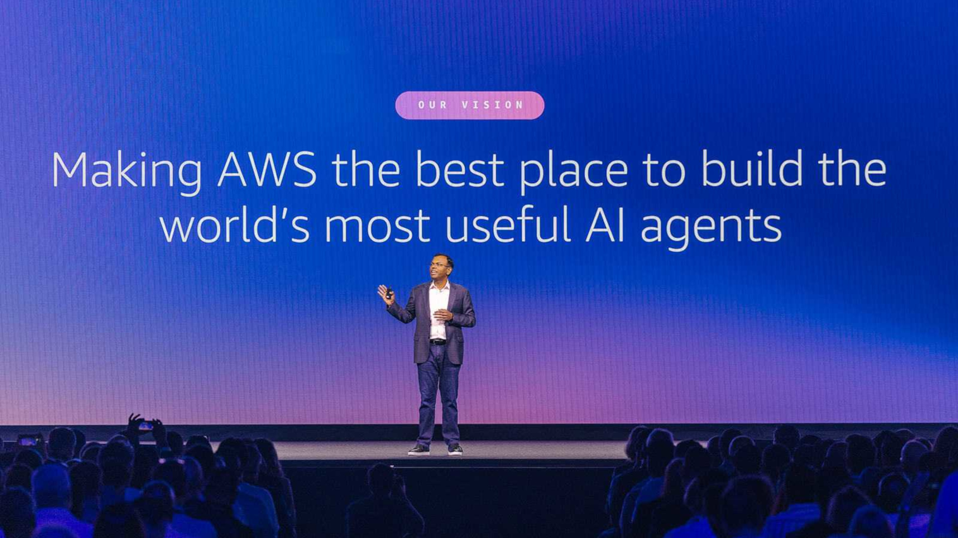 A photo of Swami Sivasubramanian, Amazon's VP of Agentic AI, standing on a stage with a background behind him stating "Making AWS the best place to build the world's most useful AI agents"