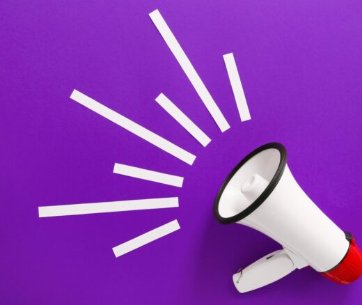 Modern megaphone on purple background