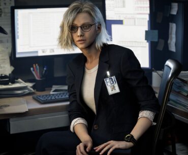 Grace Ashford at her FBI desk in Resident Evil Requiem, covered with monitors and documents