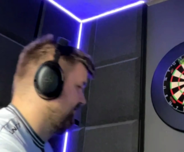 Snax playing darts during a pause in his match against Passion UA