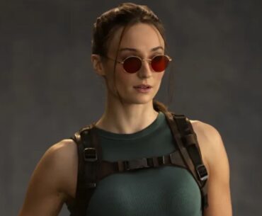 Sophie Turner dressed as Lara Croft for the Tomb Raider television show wearing sunglasses