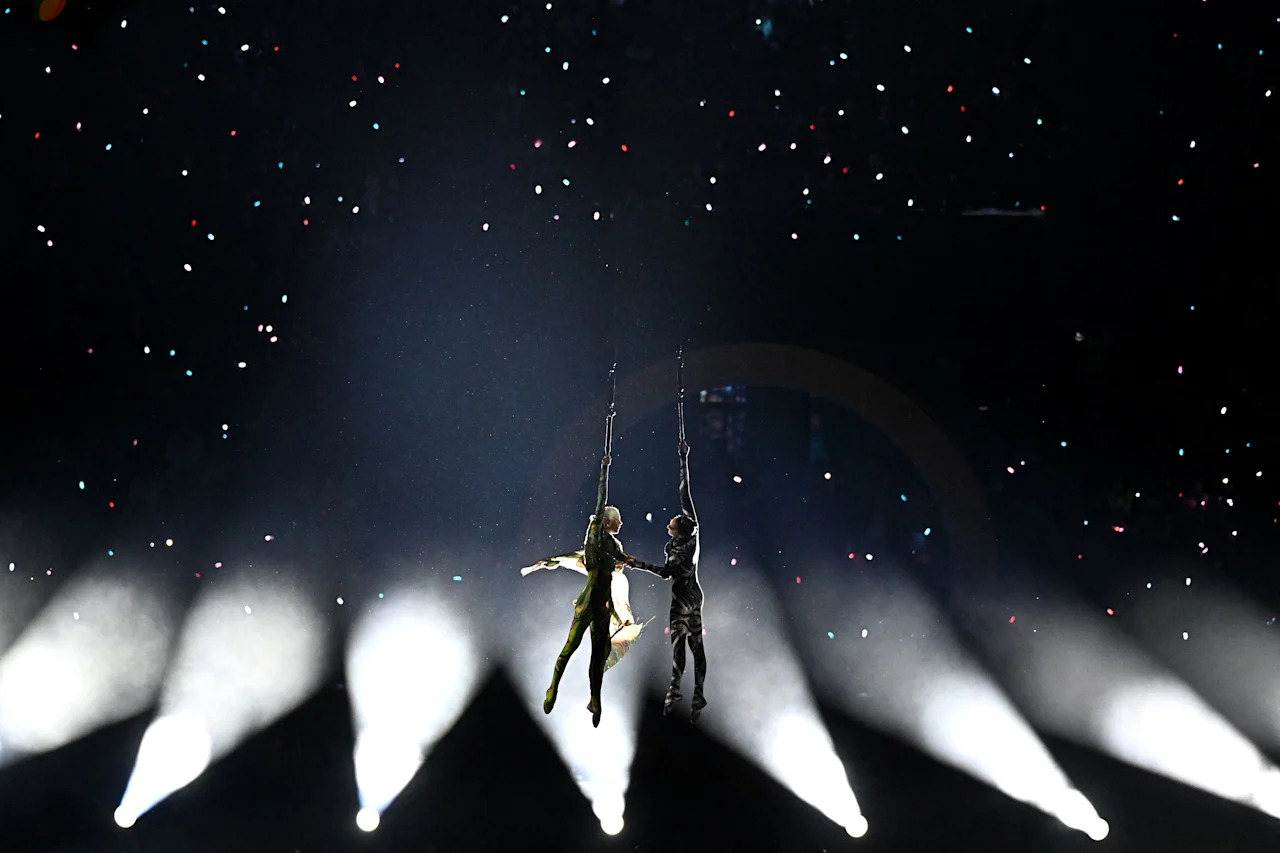 Aerialists perform during the opening ceremony of the Milano Cortina 2026 Winter Olympic Games in Milan, northern Italy, on February 6, 2026. (Photo by Gabriel BOUYS / AFP via Getty Images)