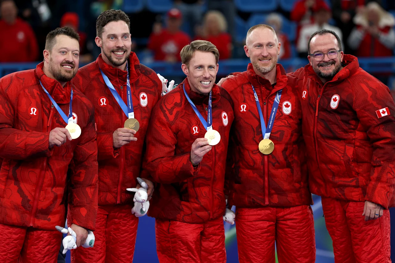 CORTINA D'AMPEZZO, ITALY - FEBRUARY 21: Gold medalists Brad Jacobs, Marc Kennedy, Brett Gallant and Ben Hebert of Team Canada and coach Paul Webster pose with their medals on the podium during the medal ceremony for the Men's Curling on day fifteen of the Milano Cortina 2026 Winter Olympic games at Cortina Curling Olympic Stadium on February 21, 2026 in Cortina d'Ampezzo, Italy. (Photo by Mattia Ozbot/Getty Images)
