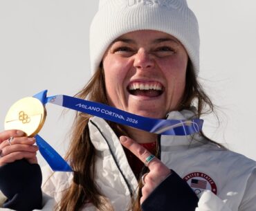 United States' Breezy Johnson shows her gold medal in the alpine ski women's downhill race, at the 2026 Winter Olympics, in Cortina d'Ampezzo, Italy, Sunday, Feb. 8, 2026.