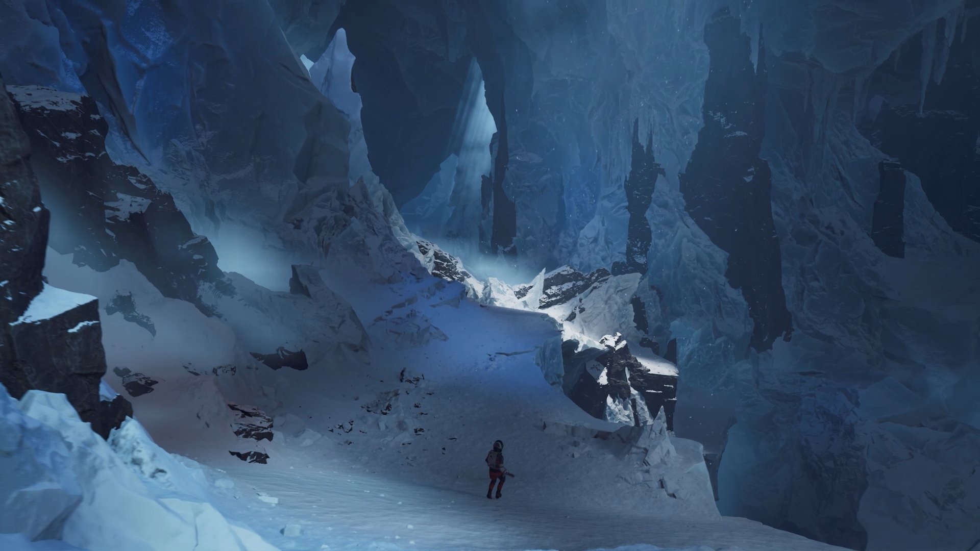 A character in a spacesuit explores a snowy, ice-covered cave environment with towering formations and soft light filtering