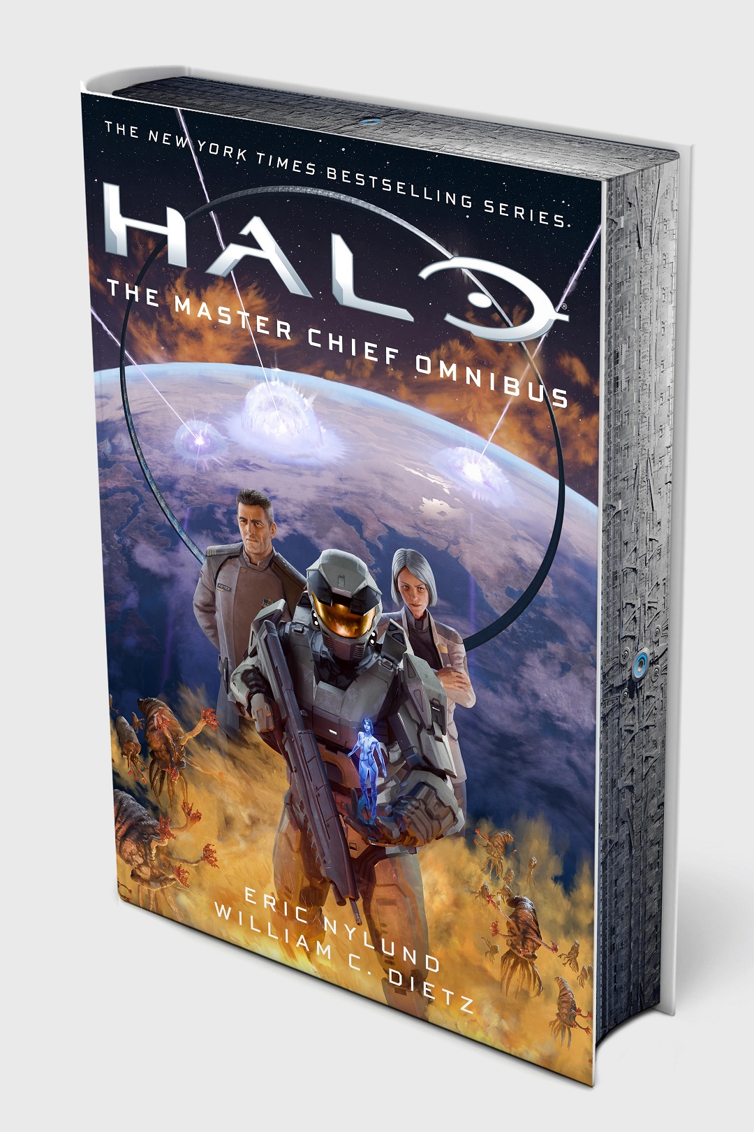 Image of the hardcover edition of Halo: The Master Chief Omnibus depicting the Master Chief, Cortana, Captain Keyes, Dr. Halsey, Reach, Alpha Halo, Flood infection forms, and the Halo ring-themed sprayed edges of the book.