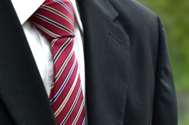 Why do some coaches wear suits instead of jogging suits at games?