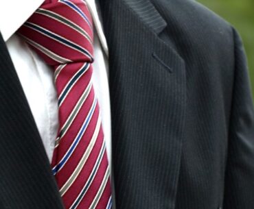 Why do some coaches wear suits instead of jogging suits at games?