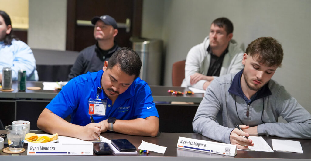 Two male students attend a seminar aimed at strengthening Oklahoma’s tribal gaming workforce.