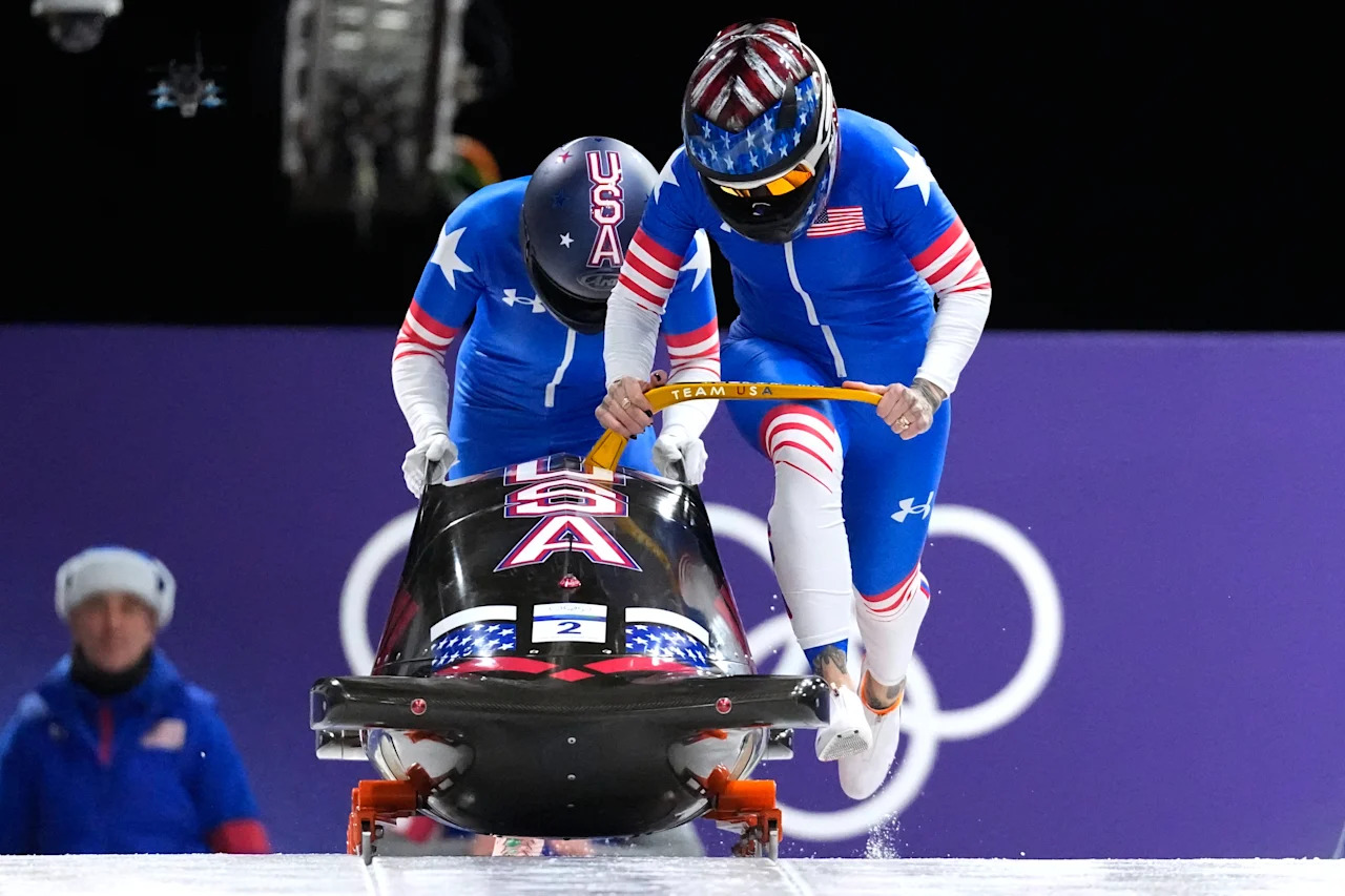United States' Kaillie Armbruster Humphries, right, and Jasmine Jones start for a two women bobsled run at the 2026 Winter Olympics, in Cortina d'Ampezzo, Italy, Saturday, Feb. 21, 2026. (AP Photo/Aijaz Rahi)