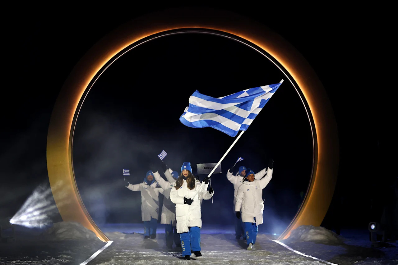 VAL DI FIEMME, ITALY - FEBRUARY 06: Flagbearer Nefeli Tita of Team Greece enters the stadium during the opening ceremony of the Milano Cortina 2026 Winter Olympics at Predazzo Ski Jumping Stadium on February 06, 2026 in Val di Fiemme, Italy. (Photo by Maddie Meyer/Getty Images)