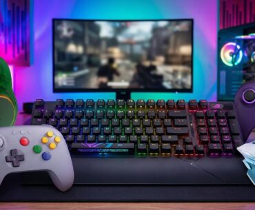 Gaming peripherals on a desk in front of a gaming pc
